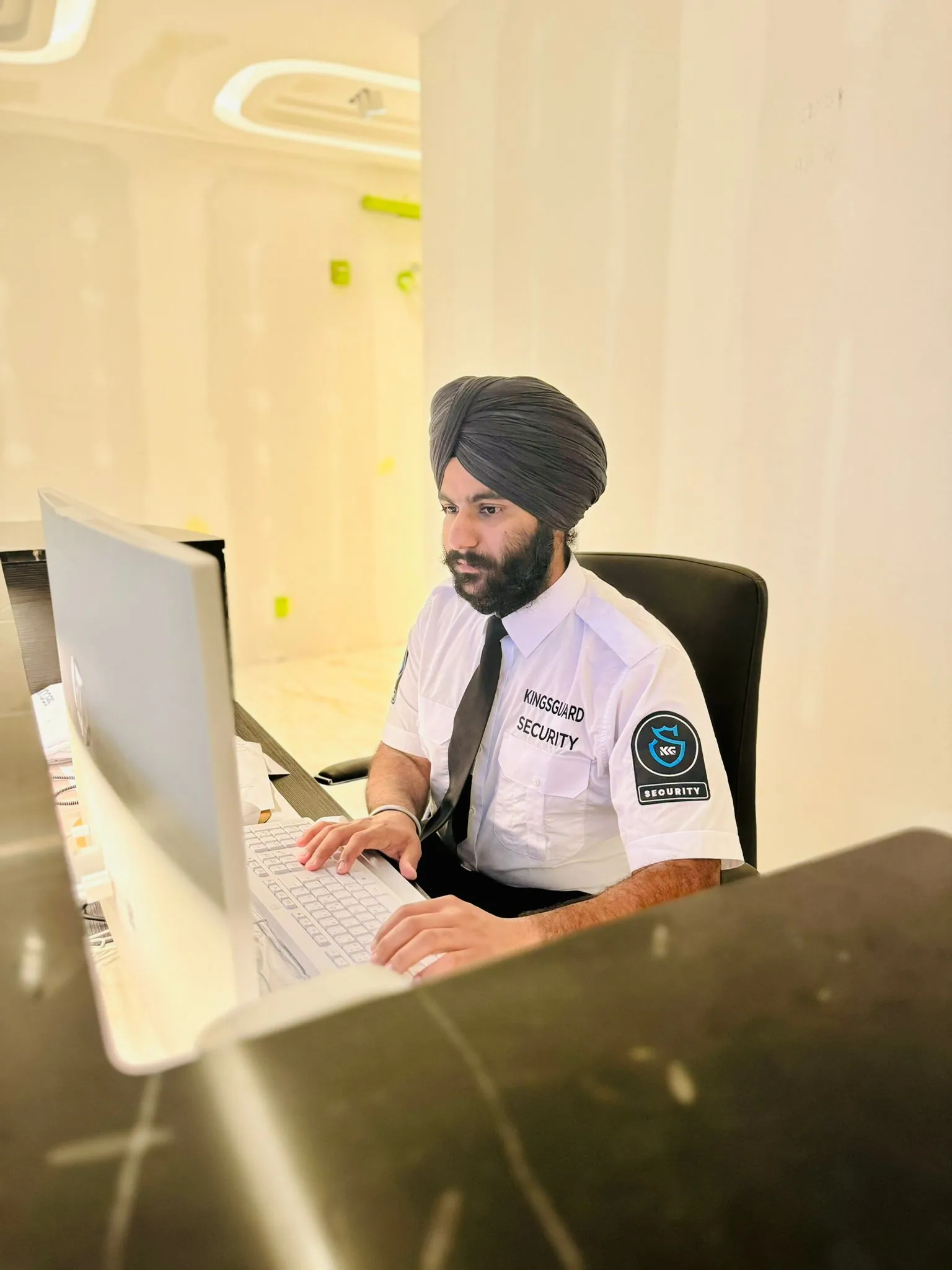 KingsGuard concierge guard at a condominium front desk