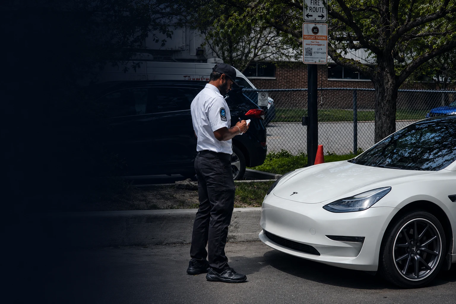 KingsGuard officer issuing a ticket in a visitor parking lot